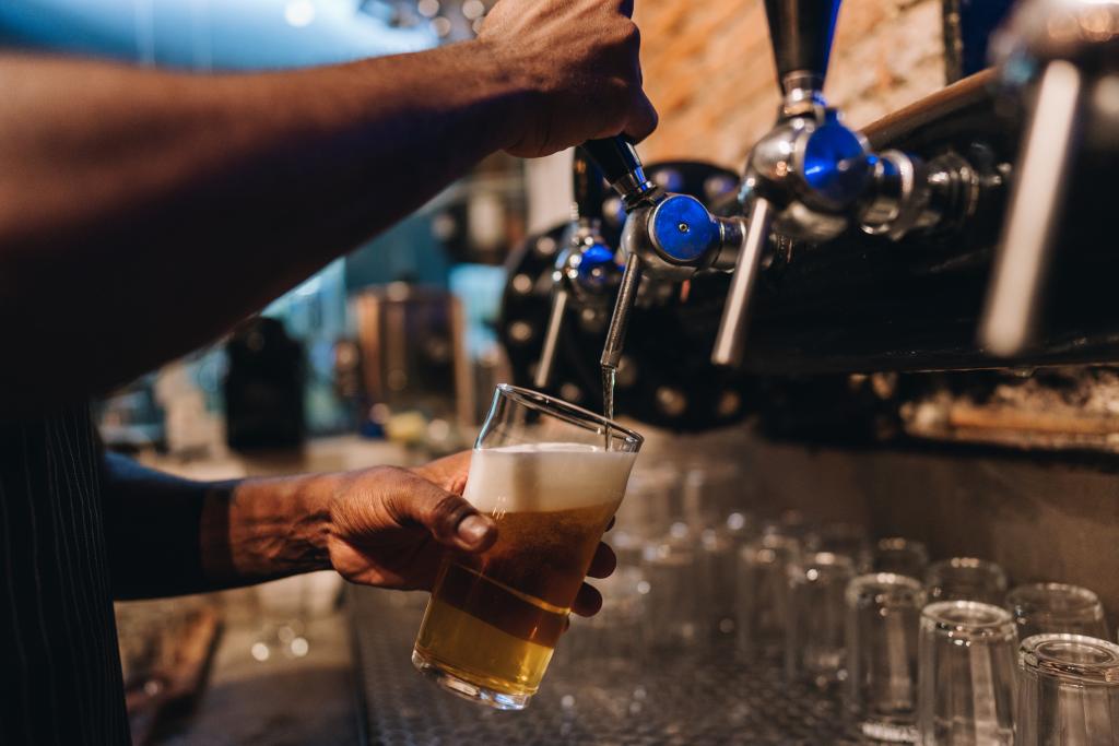 A pint being poured in a pub