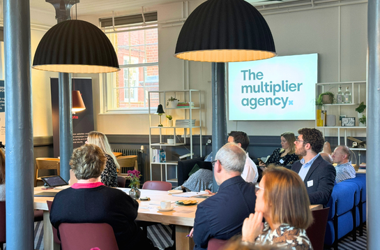 Cambridge Network peer groups: professionals listening to a speaker