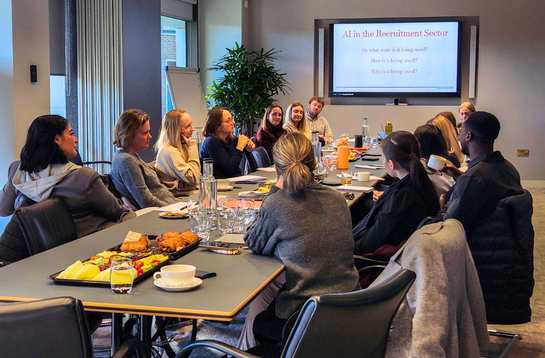 A Cambridge Network Peer Group: Professionals chatting around a board table