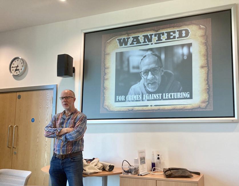 Simon in front of wanted poster