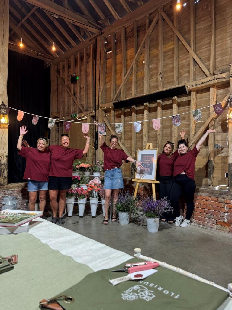a team of women with there hands in the air