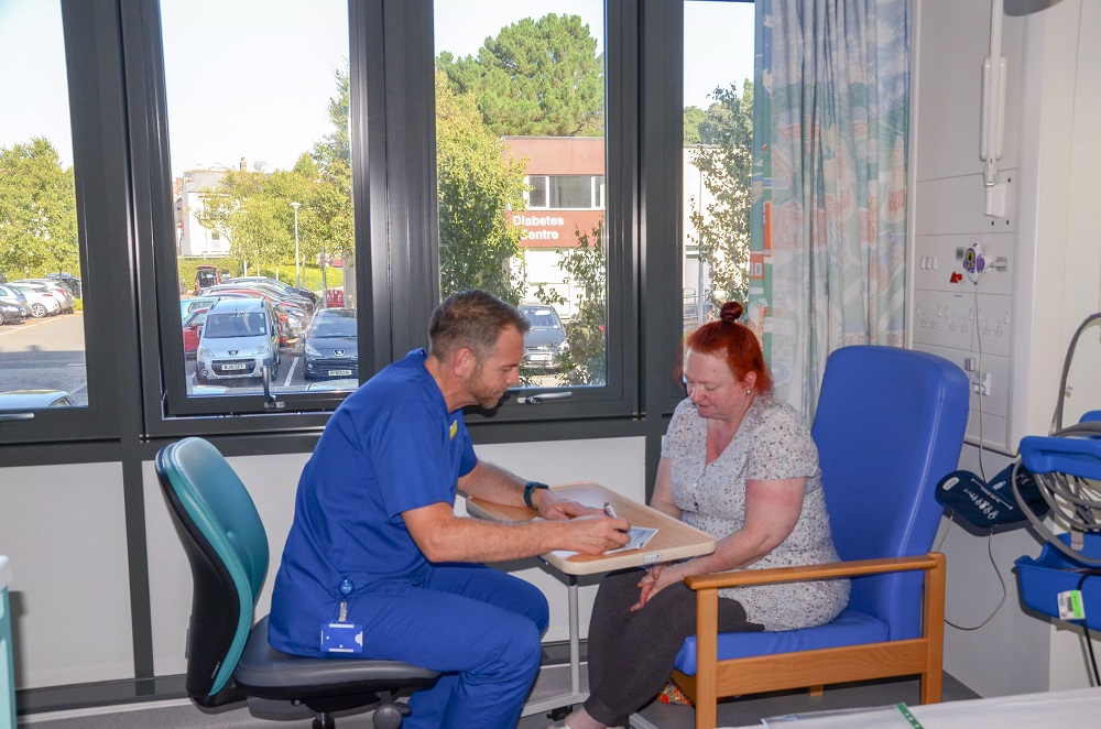 Nurse helping a patient with forms