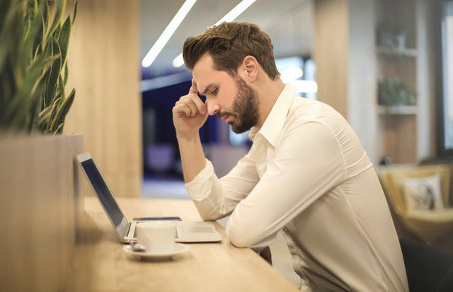 A man looking at a laptop