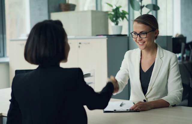 Business women shaking hands in an office