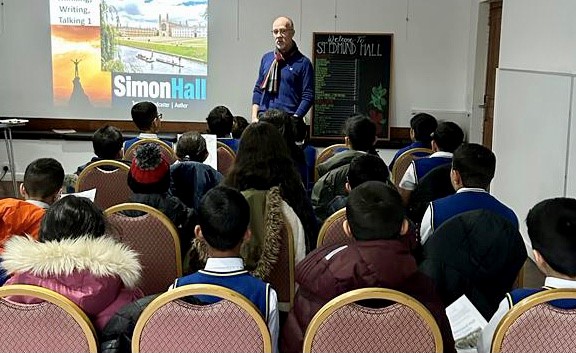 Simon teaching group of children