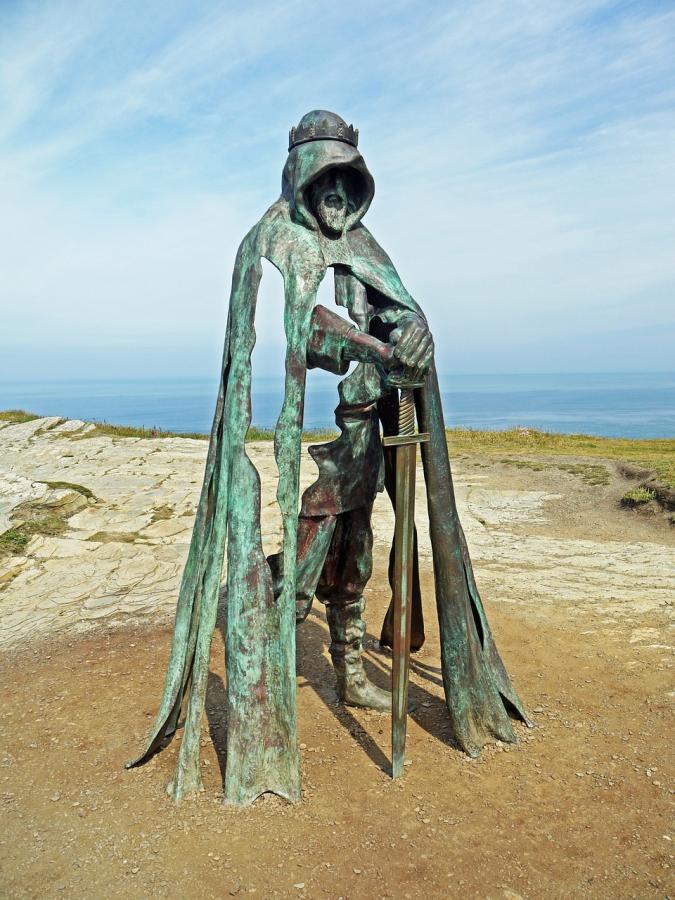 A bronze statue of a man holding a sword
