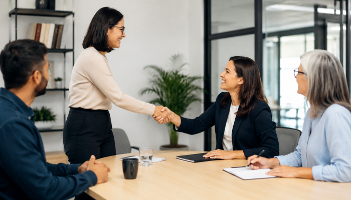 Employee being welcomed into a new internal role by colleagues, representing fair internal mobility and clearer career progression inside growing companies.