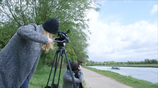Two participants from Cambridge TV Training filming by the side of the River Cam