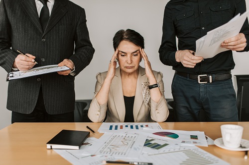Photo showing stressed woman holding her head