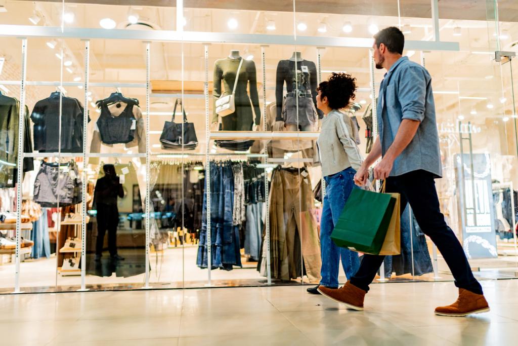 Two people walking past a shop front