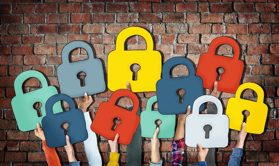 People holding security locks in-front of a wall