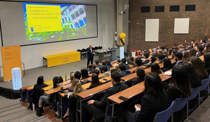 Simon giving a presentation to a large group