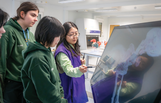 Group of students looking at a screen 