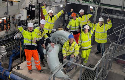 Image show RheEnergise's engineers in the system power house celebrating this major milestone.