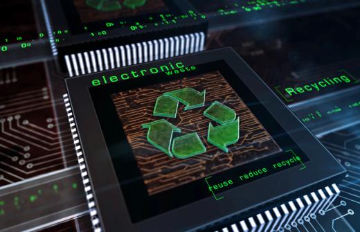 Predominant green recycling symbol, and the green words electronic waste on a technology, microchip industrial background 