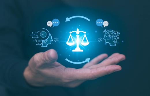 A digital illustration of a hand holding a balanced scale with a holographic human profile to one side and an AI profile to the other, with networks flowing between them to signify AI ethics, regulation and compliance. 