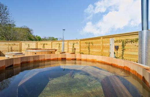 A photo of the spa area with the sky reflecting in the hot tubs
