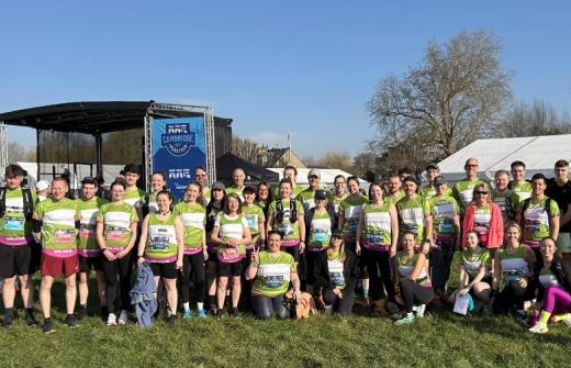 95 supporters in green running tops pose for group photo