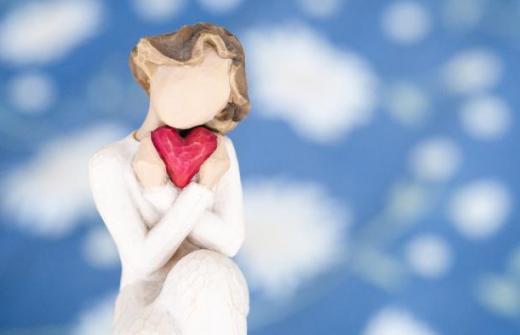 faceless 'angel' character holding a heart