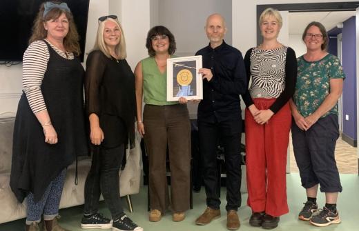Crossways staff receive Quality Mark award from Eve McCallam of Housing Justice.