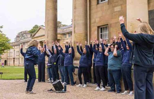 Males and females singing outside 