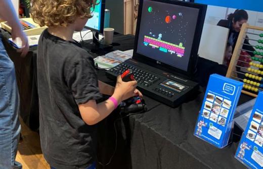 A young boy plays on a 1980s 8-bit computer game at a Centre for Computing History outreach event