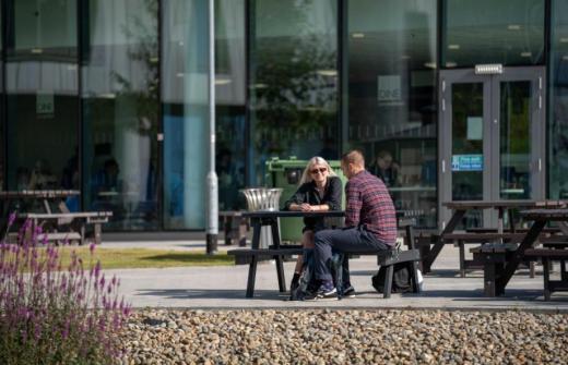 People sitting round a table outside