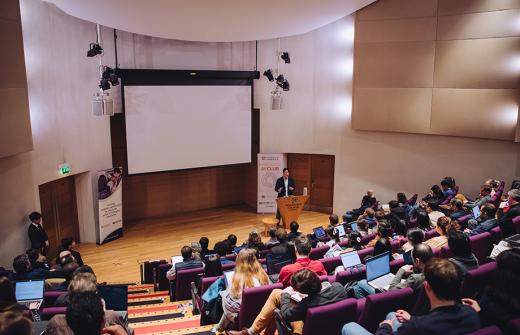 An auditorium with attendees at the workshop, watching a presentation by Dr Namshik Han