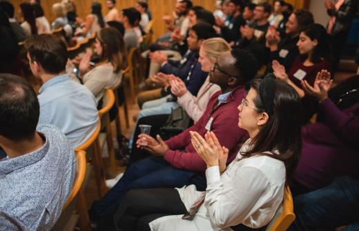 An audience applauding a speaker at an event