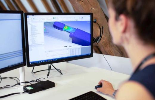 Image of a woman with an engineering model on a computer