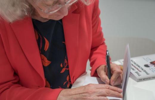 Kate Atkin signing copies of her book The Imposter Phenomenon