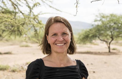 Kirsty Smith, CEO, in Kenya. She is wearing a black top and is smiling.