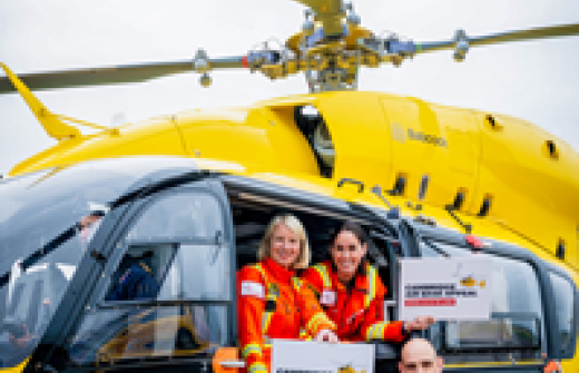 Yellow helicopter with three people with appeal signs