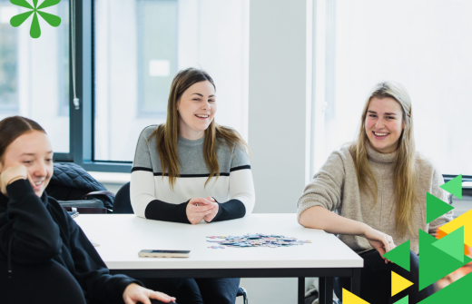 Three people sitting at a classroom table