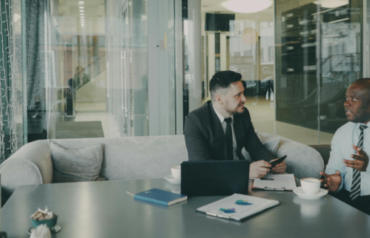 two men sitting down having a relaxed meeting