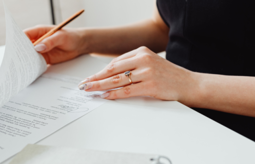 A woman signing some documents