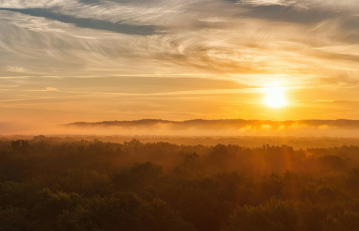 The sunset over the hills and fields