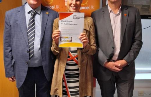 2 males and a female holding a certificate 