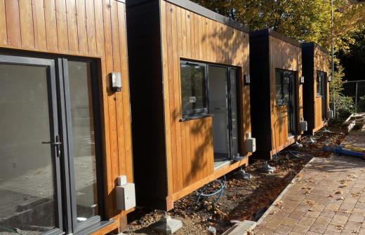 Four modular homes in a row in sunny weather