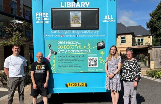 From left to right: Will Plant, Digital Inclusion Lead at Connecting Cambridgeshire; Darren Harte, Mobile Library Driver; Katherine Hesketh, Head of Communications at Keystone; and Chantal Palmer, Head of Creative at Keystone stand alongside one of the mobile library vehicles displaying the campaign graphics
