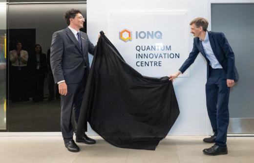 2 men revealing a plaque 