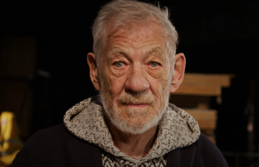Sir Ian McKellen standing on the stage of Cambridge Arts Theatre