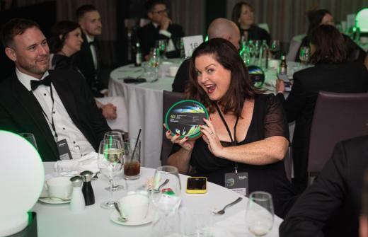 Monavate employee with award