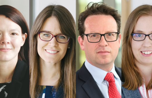 Four headshots in a line. Lady 1 has short dark hair. Lady 2 has glasses and long brown hair. Man with a red tie and glasses. Lady 3 has lighter hair with square glasses.