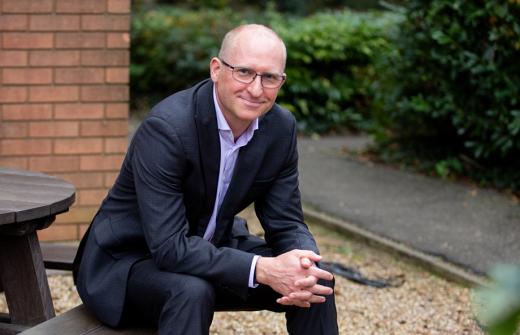 Peter Brown, chief commercial officer at 42 Technology sitting on a bench.