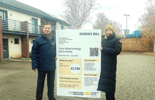 Cambridgeshire Community Foundation’s CEO, Michael O’Toole, and President, Julie Spence OBE QPM CStJ, holding an oversized energy bill.  