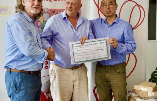 Paul (left), Tim and Freddie (right), with a cheque for The NextPath Device Consortium. 