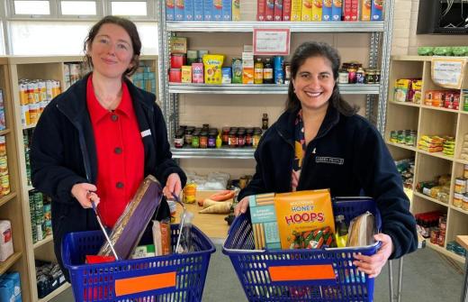 Rachel Karniely and Nicky Shepard holding baskets of food at Abbey Food Hub