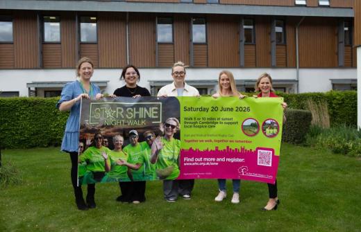 5 females holding a large banner outside 