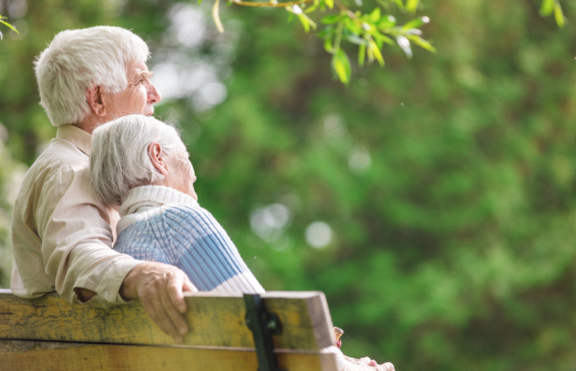A mature couple sitting on a bench